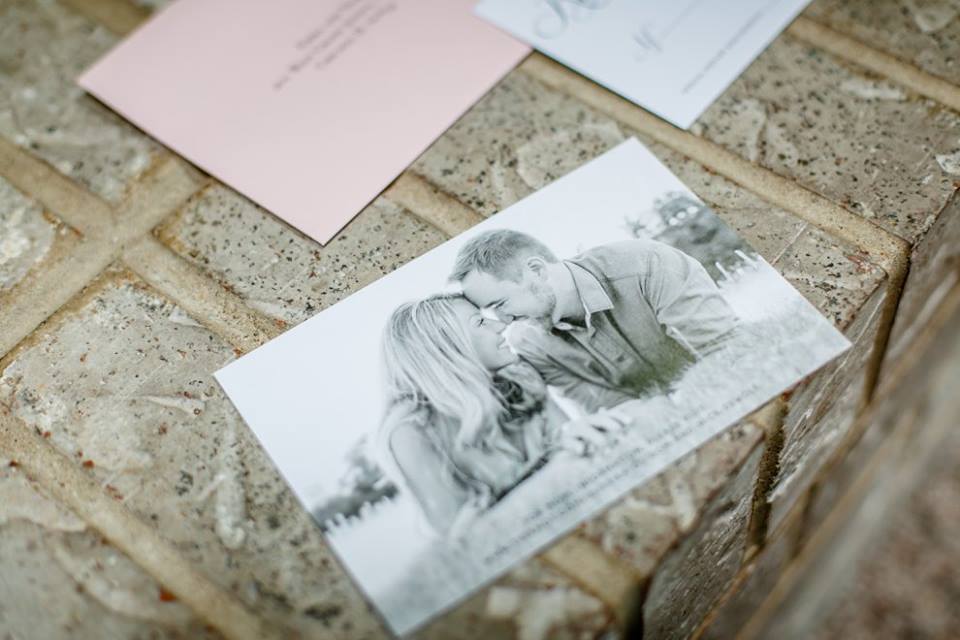 A couple's engagement photos shown on the back of a designed Save the Date card for a wedding
